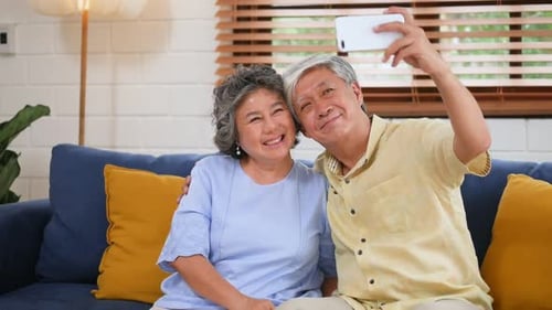 Senior Couple Posing for a Phone Selfie at Home