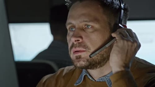 Man Talking on Headset in Office