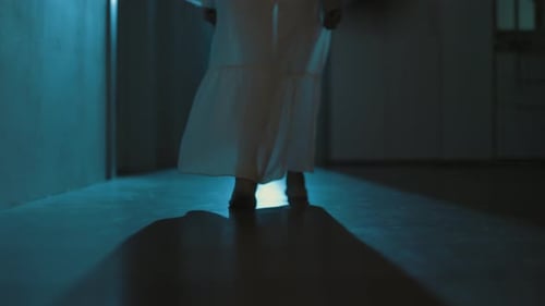 Creepy Barefoot Figure Walks Dim Hallway at Night