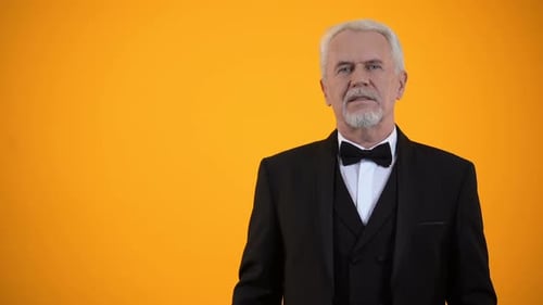 Elegant Senior Man Presents Fan of Cash