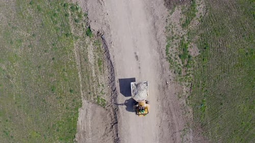 Truck Drives on a Dirt Road From Above