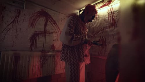 Scary Clown in Dark, Blood-Spattered Room