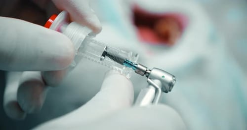 Medical Professional Using Dental Instruments