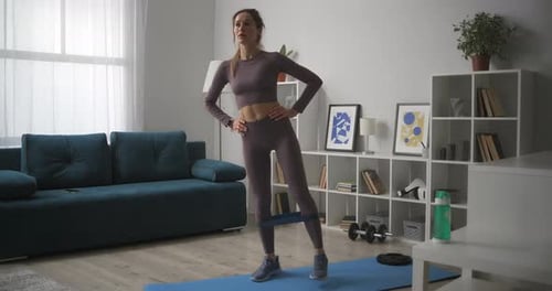 Woman Exercising with Resistance Band at Home