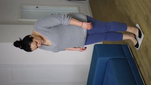 Woman Weighing Herself on Scale Indoors