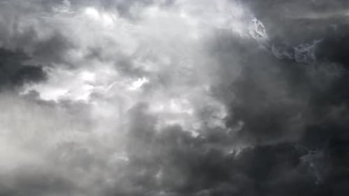 4k thunderstorm inside a thick gray cumulus cloud and dark sky.