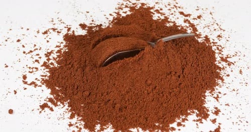 Metal Scoop Plunging Into Pile of Ground Coffee
