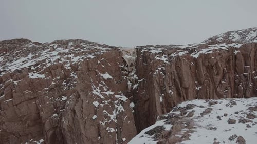 Frozen Waterfall in the Gorge of a Large Rocky Mountain and Frozen Streams of Water on the Stone