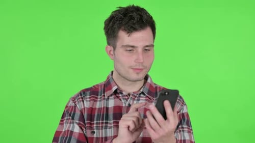 Portrait of Young Man Using Smartphone Green Chroma Screen