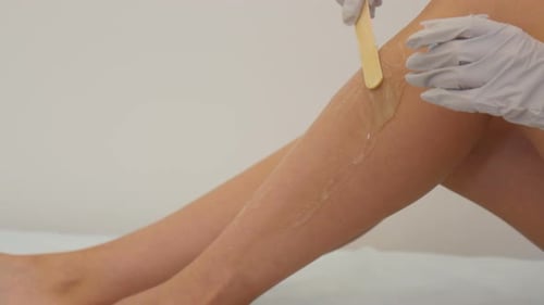 Sugar Wax Application on Woman's Leg in Spa