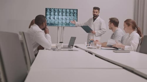 Medical Team Discussing Brain Scans in a Meeting