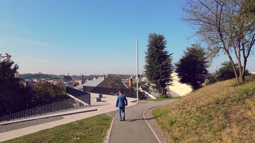Businessman Goes Forward To His Goal. A Young Successful Man in a Jacket Is on His Way To Town