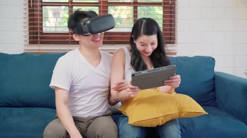 Couple Enjoying VR and Tablet Entertainment at Home