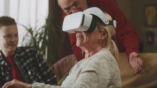 Senior Woman Enjoys Virtual Reality with Family