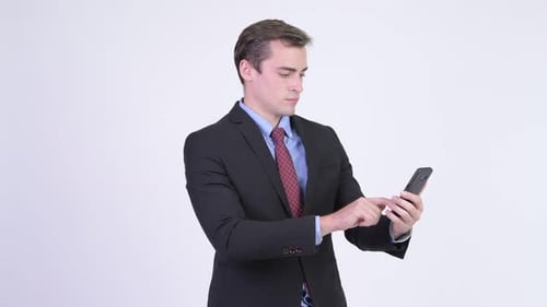 Excited Business Man Using Smart Phone Celebrates