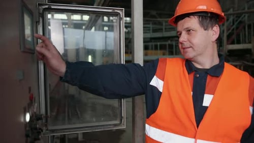Caucasian Worker in Overall Helmet on Head Pressing Button