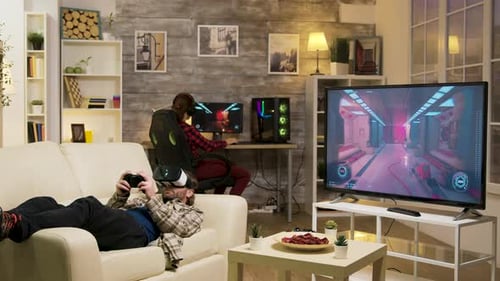 Man Lying on Sofa Playing Video Games Using Vr Headset