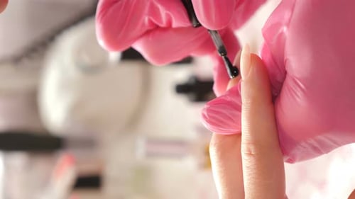 Manicurist Applying Dark Nail Polish, Close Up