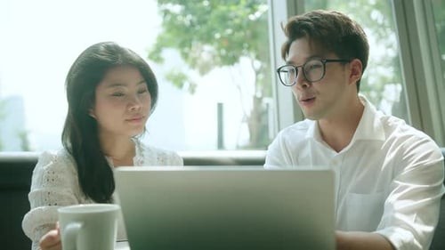 Young Adults Working Together on Laptop