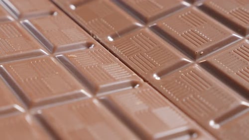 Details on dark chocolate blocks slow close-up tilt 4K 2160p 30fps UltraHD video - Perspective mad