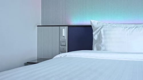 Hotel Bed with White Linens and Pillows