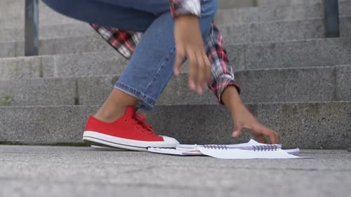 Pretty Student Girl Going Up Stairs and Dropping Her Notebooks, Picking Them Up