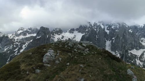 Flying Over the Top of the Mountain Towards the Higher and Snowy Mountains, Aerial