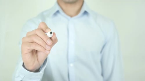 Man Writes the Word Coach on Glass