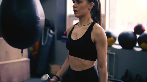 Strong Woman Lifting Weights at the Gym