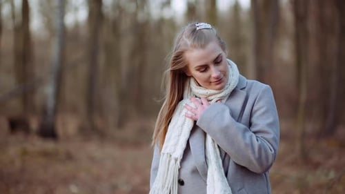 Portrait of Positive Woman Walking in Park in Autumn