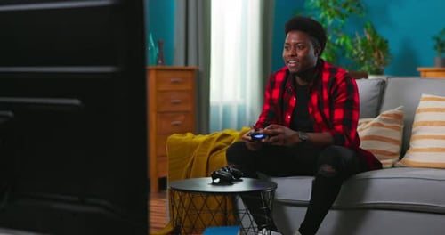 Man Playing Video Game on Television at Home