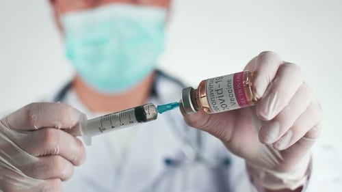 Medical Professional Filling Syringe With Vaccine