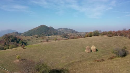 Autumn mountain with peaks, meadows and colorful forests