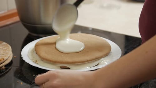 Woman Greases The Cakes