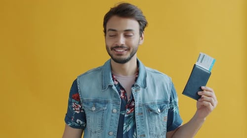 Young Adult Holds Passport and Toy Airplane