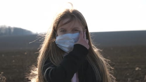 Portrait of Little Girl with Medical Face Mask Standing Outdoor