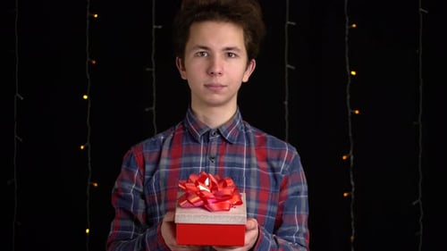 Young Adult Holding out a Birthday Gift