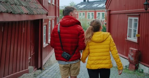 Couple Walking Through European City Street