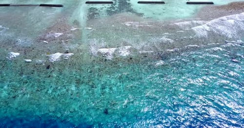 Beautiful flying tourism shot of a white sand paradise beach and aqua turquoise water background in