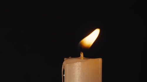 Burning Wax Candle on Black Chroma Key Background