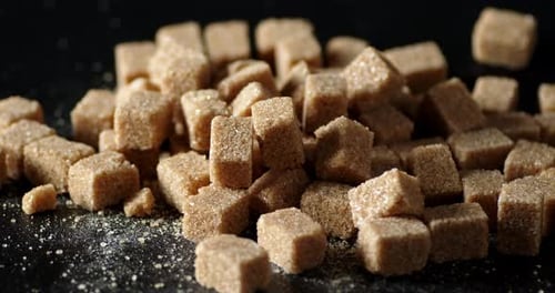 The Brown Sugar Cubes Rotate Slowly on the Table