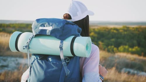 Woman Hiking with Backpack in Rural Landscape
