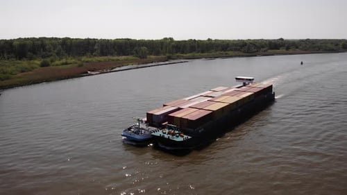Intermodal Containers Transported By Inland Vessel Cruising In The River. - aerial