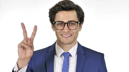 Smiling Man Makes Peace Sign in Business Suit