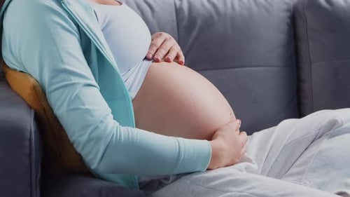 Pregnant Woman Gently Holding Her Belly
