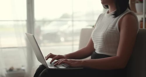 Woman Typing on Laptop at Home Office