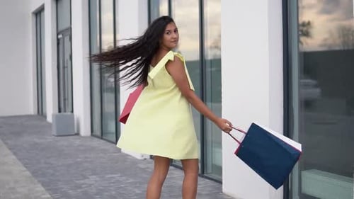 Stylish Woman Posing with Shopping Bags Outdoors