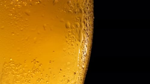 Half a Beer Glass with Falling Water Drops