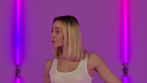 Beautiful Young Woman Posing on Purple Background