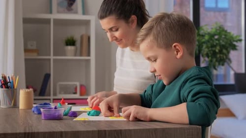 Woman and Child Working with Modeling Clay at Desk
